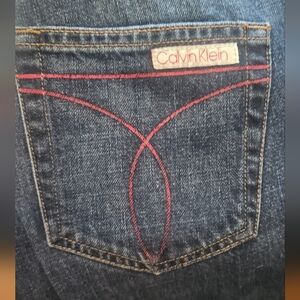 Vintage Calvin Klein Women's Dark Blue Jeans with Pink Detail. Size 7